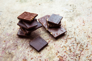 Dark chocolate stack with hazelnuts. Sweet dessert