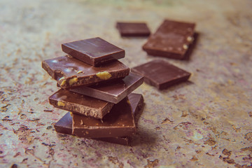 Dark chocolate stack with hazelnuts. Sweet dessert