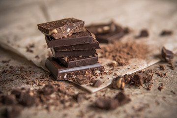 Dark chocolate stack with hazelnuts, selective focus