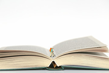 Reading concept. journey into the world of books. Traveler's figure on the pages of books on a white background
