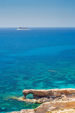 Fifla island and window near Tal-Ħamrija Coastal Tower, Malta
