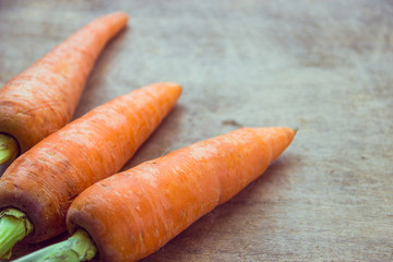Young fresh carrots on wooden background. Organic natural food