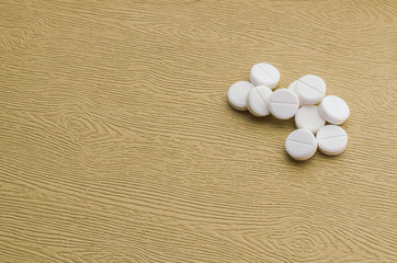 Fototapeta na wymiar Several white tablets on a wooden table