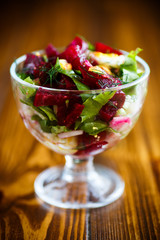 Salad from boiled beet with eggs and fresh vegetables