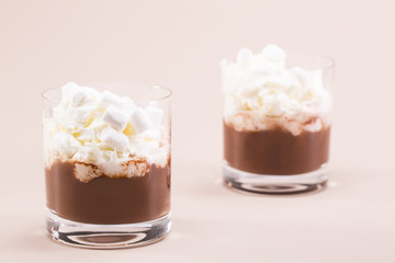 Two glasses of cocoa with whipped cream and marshmallows