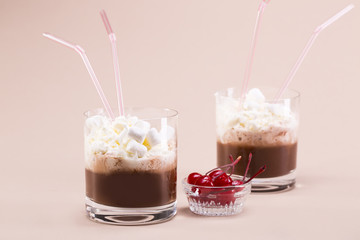 Two glasses of cocoa with whipped cream and marshmallows