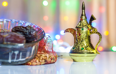 Ramadan, Eid concept background of Date fruit  and Arabic Coffee pot with illuminated out of focus lights