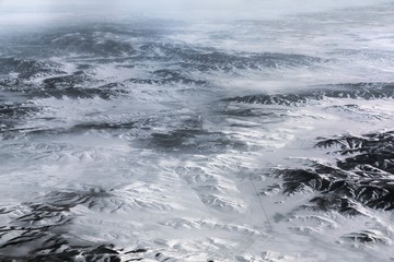 Aerial view above the Himalayas with city at center