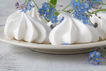 Meringue with forget-me-nots flowers