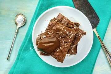 Overhead photo of chocolate brownies on teal textures