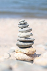 Fototapeta na wymiar Balance stone on sea coast. Zen rocks on the beach. Feng Shui balance