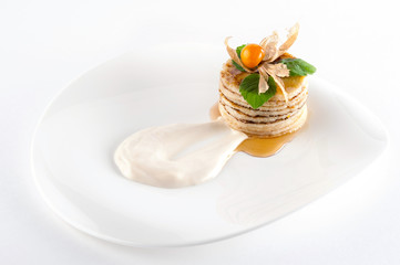 Almond pancakes with maple syrup and sour cream isolated on white background