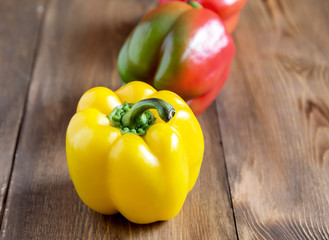 Raw beautiful yellow and red peppers on wooden background Close up Vegetable Healthy and diet food