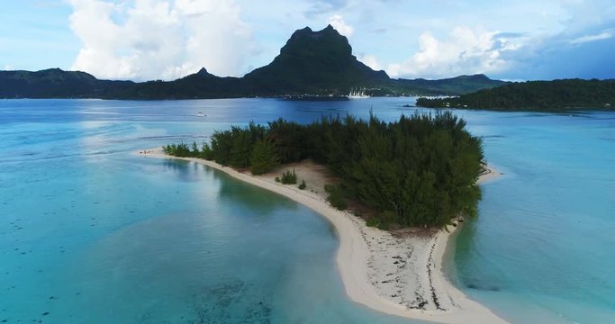 Bora Bora in French Polynesia. Aerial view of Motu paradise island and turquoise blue water in coral reef lagoon and Mt Pahia, Mount Otemanu, Tahiti, South Pacific Ocean.