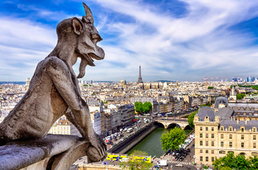 Naklejka na ściany i meble Gargoyle on Notre Dame de Paris on background of skyline of Paris, France.