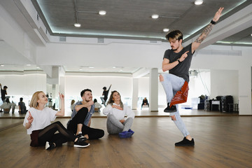 Group of young modern dancers dancing in the studio. Sport, dancing and urban culture concept
