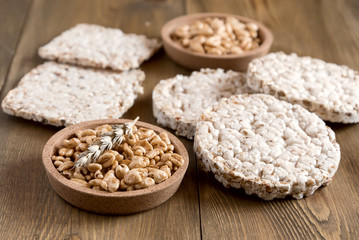 Many different kinds of products made from wheat diet crisp breads lying on wooden background Healthy organic food Rustic