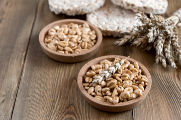 Many different kinds of products made from wheat diet crisp breads lying on wooden background Healthy organic food Rustic Copy space