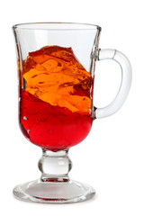 Fruit cocktail in a glass goblet on a white background
