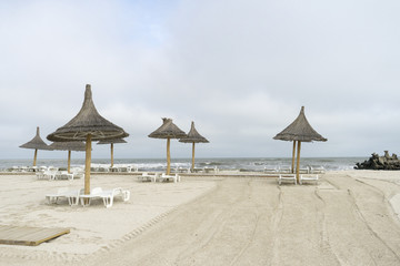 Landscape with The Black sea, sand and beach elements photographed in Gura Portitei, Romania, in a foggy spring day