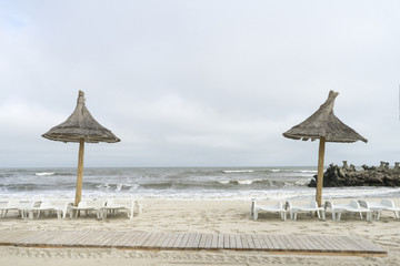 Landscape with The Black sea, sand and beach elements photographed in Gura Portitei, Romania, in a foggy spring day