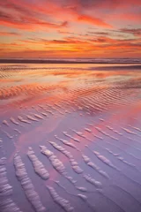 Gardinen Beautiful sunset and reflections on the beach at low tide © sara_winter