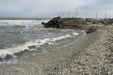 Seascape with breakwater irregularly arranged on seaside, at Gura Portitei, Romania