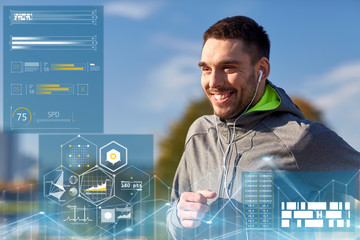 happy man with earphones running in city