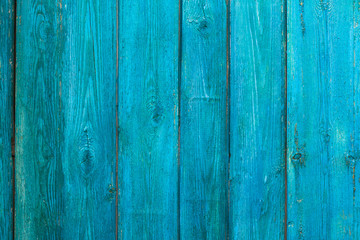 Fototapeta na wymiar Vintage wooden texture of an old fence painted blue. Vertical texture on background