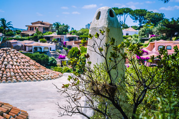 Cute mediterranean white houses with tile roofs of Porto Rafael, Palau, Sardinia, Italy