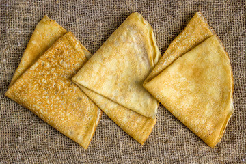 Thin Pancakes on a Sacking Background Top View. Fresh Homemade Crepes.