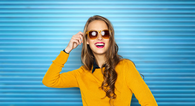 happy young woman or teen girl in sunglasses