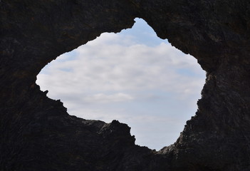 Australia rock and ocean in Narooma. The shape of Australia cut into the rock wall was accidental and was created when a ship was tied to the rock with large chains to prevent it from washing away.