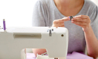 tailor woman with spool of sewing machine