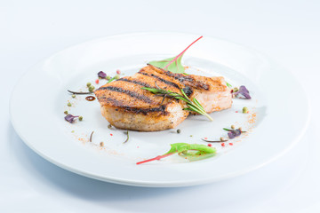 cooked pork steak at a white plate