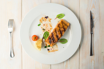 table setting with cooked salmon