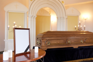 photo frame and coffin at funeral in church