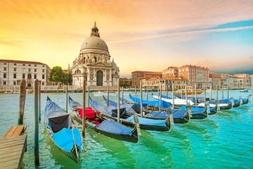 Fototapeta na wymiar Incredible optimistic color landscape of gondolas on the Grand Canal in the background Basilica Santa Maria della Salutein at dawn in Venice, Italy, Europe. (Romantic travel, honeymoon - concept)