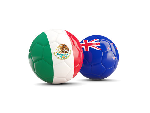 Two footballs with flags of Mexico and New Zealand isolated on white