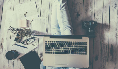 Relaxing work at home: concept with a girl sitting on the floor with laptopand other tools