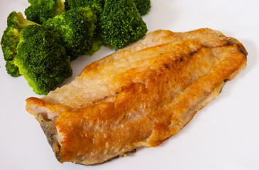 fish fillet with broccoli on plate