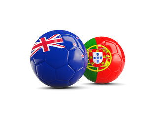 Obraz premium Two footballs with flags of New Zealand and Portugal isolated on white