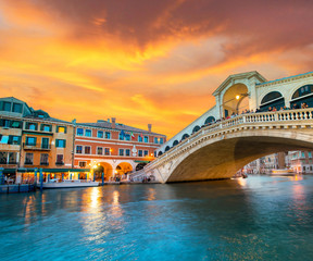 Fototapeta na wymiar Bright charming landscape with Rialto Bridge at sunset in Venice, Italy, Europe