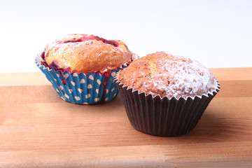 Homemade Blueberry muffins with powdered sugar and fresh berries.