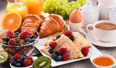 Breakfast served with coffee, juice, croissants and fruits