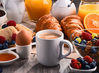 Breakfast served with coffee, juice, croissants and fruits