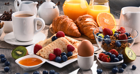 Breakfast served with coffee, juice, croissants and fruits