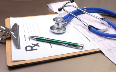 RX prescription, Red heart, asorted pils and a stethoscope on white background