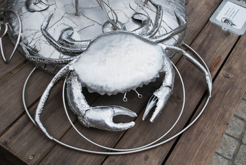 A silver crab sculpture in an artisan market in South Africa