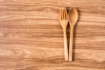 Wooden spoon and fork with wooden table.